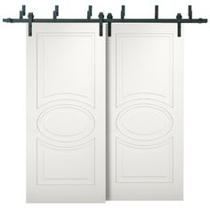 two white doors with black metal bars on each side and an oval design in the middle