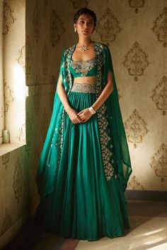 Shop for Mrunalini Rao Green Floral Embroidered Cape Lehenga Set for Women Online at Aza Fashions Bottle Green Outfit Women, Bottle Green Indian Outfit, Rama Green Lehenga, Celebrity Dresses Indian, Buttis Embroidery, Bottle Green Lehenga, Cape Organza, Mehandi Dress, Mehendi Dress