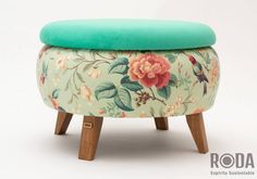 a foot stool with a flower pattern on it and a green cushion over the top