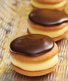 two chocolate covered donuts sitting on top of a table