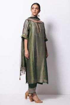 Olive panelled handwoven kurta with zardozi floral motif embroidered placket and sleeves. Paired with cotton silk pant and stole with tassels. Comes with slip.
Component: 4
Pattern: Embroidered
Type Of Work: Floral Motifs
Neckline: Round
Sleeve Type: Elbow
Fabric: Kurta: Handwoven Chanderi Silk; Stole: Chanderi; Pant: Cotton Silk
Color: Green
Other Details: 
Front concealed placket
Side slit kurta
Kasab thread zari tassels
Side pocketed kurta
Zari detailed pant hem
Occasion: Puja - Aza Fashions Silk Kurta Set, Designer Anarkali Dresses, Chanderi Dupatta, Silk Stoles, Silk Pant, Zardozi Embroidery, Suit Pattern, Designer Anarkali, Silk Kurta