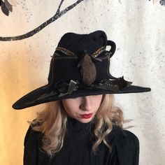 "A fancy witch hat with a large 3D needle felted bat gracing the front and crisscrossed in back with black velvet ribbon. The dimensions are approximately 15\" across and 10\" deep from brim to the top of the curly point. The point is reinforced with wire allowing you to position it however you like. The brim is bound in black Dupioni silk. How to measure your head: Use a soft measuring tape and measure around the middle of your forehead above the ears, and at the tightness you are comfortable w Black Brimmed Witchy Costume Hat, Witchy Black Brimmed Costume Hat, Black Witchy Brimmed Costume Hat, Witchy Black Costume Hats And Headpieces For Fall, Witchy Black Costume Hat For Fall, Black Felt Hat For Halloween Costume, Black Witchy Hat With Curved Brim, Black Brimmed Witchy Hat, Black Witchy Brimmed Hat