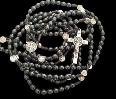 NEW - UNIQUE This is a full rosary which includes all 20 decades or 15 decades by your choice. Its made of a  wood beads. The beads are strung on a strong cord for durability. The center is made of metal medal. The centerpiece is double sided. St. Benedict Crucifix. THE 20 decade ROSARY IS 132 CM (52inches) LONG ! THE 15 decade ROSARY IS 105 CM (41,5inches) LONG ! The beads size 8mm. This is a long rosary and you can use it to pray all four mysteries: Joyful, Luminous, Sorrowful, and Glorious. T Black Wooden Beads Rosary Spiritual Style, Black Wooden Beads Rosary, Black Wooden Beads Spiritual Rosary, Decade Rosary, St Benedict, Saint Benedict, Black Wood, Rosary, Wood Beads