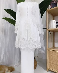 a mannequin with a white dress and veil on it