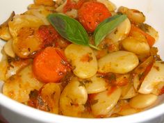 a white bowl filled with pasta and vegetables