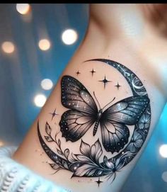 a woman's arm with a butterfly on the moon and stars in the sky