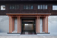 the entrance to an apartment building with wooden slats on the front and side walls