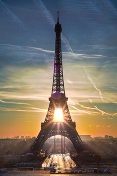 the eiffel tower is lit up at sunset