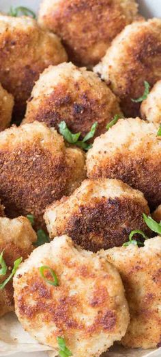 fried meatballs with parsley on top in a white bowl, ready to be eaten