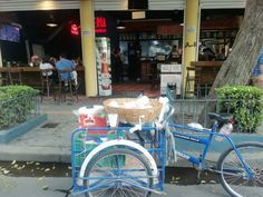 two bicycles parked next to each other in front of a building