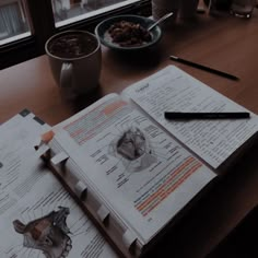 an open book sitting on top of a wooden table