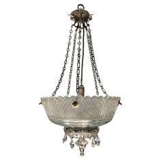 a chandelier hanging from the ceiling with glass shades and chains attached to it