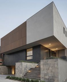 an exterior view of a modern house with stone steps