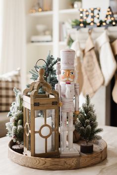 a wooden nutcracker with a lantern and christmas tree