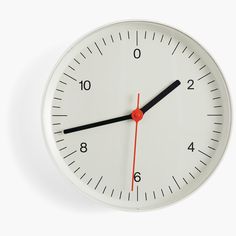 a white clock with red hands and numbers on the face is shown against a white background