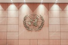 the emblem of the united nations is displayed on a wall in an office building stock photo