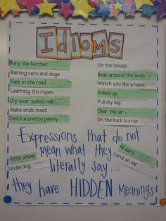 a bulletin board with writing on it and stars around the edges that read, idioms