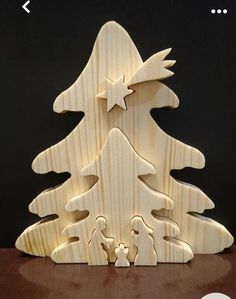 a wooden christmas tree is shown on a table