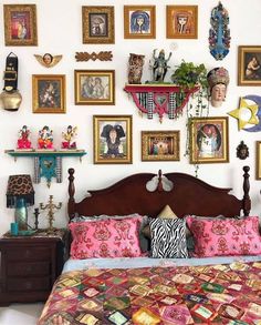 a bed with many pictures on the wall above it