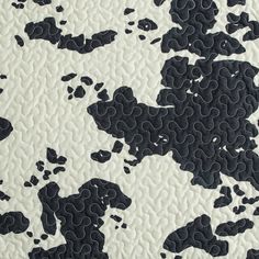 the black and white pattern is made up of small pieces of paper with holes in it