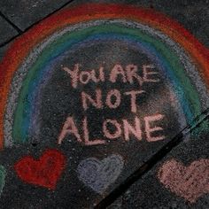 someone wrote this message on the sidewalk in front of their house that says, you are not alone