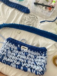 several crocheted items are laid out on a bed