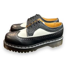 Add A Touch Of Sophistication To Your Casual Look With These Dr. Martens Black White Smooth Leather Wingtip Bex Chunky Oxfords. Made For Men, These Shoes Are Size 7 And Feature A Comfortable Loafer Style. The Black Color Of The Leather Upper Material Complements The White Smooth Wingtip Design And Chunky Sole. The Brand Is Well Known For Its Quality Products And This Pair Of Shoes Is No Exception. Perfect For Any Casual Occasion, These Shoes Are A Must-Have For Any Fashion-Conscious Man. Retro Black Oxfords For Derby, Retro Black Oxfords With Leather Sole, Retro Black Wingtip Oxfords, Black Leather Retro Oxfords, Chunky Sole Shoes, Chunky Oxfords, Mens Platform Shoes, White Dr Martens, Comfortable Loafers