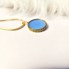 Chalcedony pendant necklace gold,round,blue,flat pendant,gift for her,women jewelry,aqua,gemstone,unique,simple,18k gold,vintage style  necklace size:18" pendant diameter:25mm Thickness:3mm Add this beautiful chalcedony ocean blue pendant gold  necklace. This pendant is inspired by vintage jewellery. Sets well around the neck and looks amazing. Gold Plated Necklaces With Gemstone Round Pendant, Gold Plated Gemstone Round Pendant Necklace, Gold Plated Necklaces With Round Gemstone Pendant, Gold Plated Round Pendant Necklaces With Gemstone, Gold Plated Necklace With Round Gemstone Pendant, Elegant Round Cabochon Necklaces, Elegant Light Blue Round Pendant Necklace, Elegant Circle Gemstone Jewelry, Sapphire Gemstone Round Pendant Necklaces