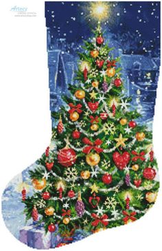 a cross stitch christmas stocking with an image of a tree and presents on it