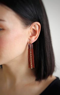 Elevate your look with these boho chic gold stud earrings featuring a stunning beaded tassel design in dark topaz. These statement long earrings in brown and gold exude an elegant charm that will surely turn heads. The glamorous dark topaz beaded tassel earrings are accentuated by trendy gold studs, making them a must-have statement jewelry piece for any occasion. Add a touch of sophistication and style to your outfit with these exquisite earrings! These earrings are very lightweight and extreme Brown Dangle Earrings With Tassels, Elegant Brown Beaded Chandelier Earrings, Handmade Brown Tassel Earrings, Brown Fringe Tassel Earrings For Gift, Brown Fringe Tassel Earrings As Gift, Brown Fringed Tassel Earrings Gift, Bohemian Brown Beaded Earrings For Party, Elegant Brown Chandelier Earrings, Brown Beaded Drop Earrings For Party