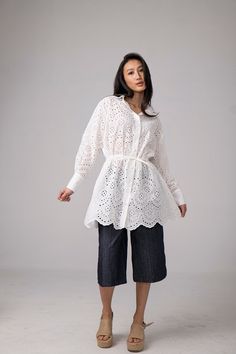 ABOUT THE COTTON LACE SHIRT: Elevate your wardrobe with timeless sophistication with our Shirt Lace Dress. Embrace the delicate allure of lace in chic shirt dress styles, perfect for both casual and formal occasions. Discover the epitome of elegance and charm with L'EICNÉCRAcasual's exquisite lace creations. *COMPOSITION* Cotton Lace *CARE* Gentle hand wash 30oC Model is wearing size S. She is 5'9"/170 cm tall. This piece is available in sizes from XS, S, M, L, XL, XXL *COLORS* The dress's color Beach Tunic, Chic Shirts, Dress Long Sleeves, Lace Dress Long, Shirt Dress Style, Vintage Beach, Lace Shirt, Summer Cotton, Cotton Lace