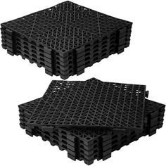 two black plastic pallets stacked on top of each other with holes in the middle