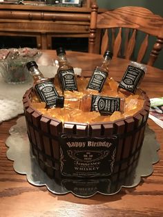 a birthday cake with bottles of whiskey on it