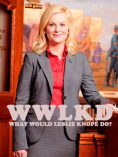 a woman standing in front of a painting with the words wlkd what would lesie knope do?