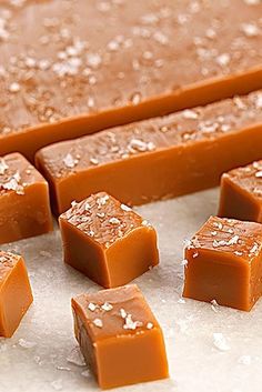 several pieces of chocolate sitting on top of a table covered in sea salt and flakes