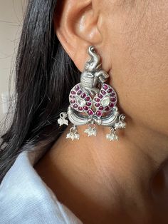 RESTOCKED ♥️ Silver Jewellery at its best!/ One of a Kind  The one of a kind  earrings are beautifully crafted by our skilled Indian craftsmen with kemp stones and kundan stones on pure silver. You will definitely fall in love with the elegant elephant design in antique polish. The pearl tassels at the bottom add a perfect charm to the stunning pair of earrings. Premium quality  Material : 92.5 real silver , antique polish  Hallmarked   Length of earrings: 6 cms    Width of earrings: 3.8 cms Handmade Fusion Style Ceremonial Earrings, Kemp Earrings, Jewellery South Indian, Pearl Tassels, Silver Jewlery, Silver Elephant, Jewellery Vintage, Earrings Art, Silver Elephants