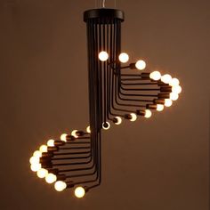 a chandelier with lights hanging from it's sides in the shape of circles