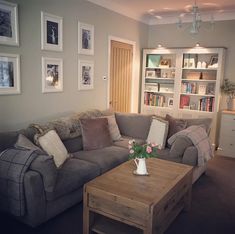 a living room filled with furniture and pictures on the wall