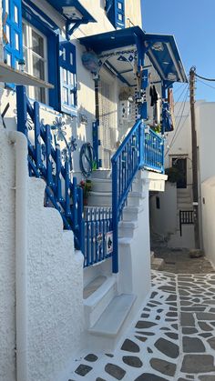 a white and blue building with steps leading up to it