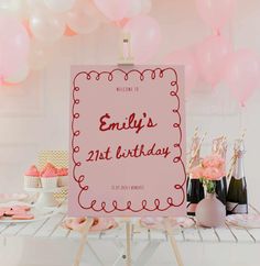 a pink birthday sign sitting on top of a table