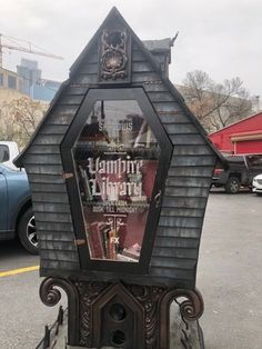 an old fashioned newspaper dispenser sitting in the middle of a parking lot