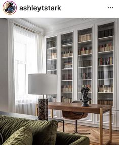 a living room filled with furniture and bookshelves