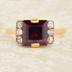 A stunning art deco 18ct gold garnet & diamond dress ring. A wonderous central deep red rhodolite garnet is set neatly within this very stylish ring. It is flanked either side by a trio of warm and deep bright white old cut diamonds which compliment it perfectly. The clean geometric design oozes with character and is typical of the art deco period. A part of our art deco ring collection. SIZE UK O / US 7 - Free sizing available  SPECIFICATION Garnet carat weight approx. 2.7 carat Diamonds total Formal Garnet Burgundy Ring, Formal Burgundy Garnet Ring, Elegant Burgundy Garnet Rings, Elegant Garnet Ring With Rose Cut Diamonds, Classic Burgundy Ruby Ring For Formal Occasions, Art Deco Ruby Jewelry For Formal Occasions, Formal Garnet Ring With Center Stone, Formal Burgundy Gemstone Jewelry, Classic Formal Burgundy Rings