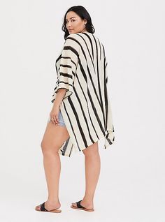 A striped ruana gives you an instant boho look, while lightweight fabric keeps you feeling (and looking) cool all summer long. Open front. Side self-tie; vented. 3/4 sleeves. CONTENT + CARE: Acrylic. Hand wash; dry flat. Imported plus size kimono. SIZE + FIT: Model is 5'10”. This item is One Size and measures 37. 25” from shoulder . The best plus size women's ivory & black stripe ruana capes ponchos ruanas in ivory. Torrid is your destination for cozy fall and winter clothes to keep you warm and Plus Size Kimono, Capes & Ponchos, Print Kimonos, Boho Look, Floral Chiffon, Winter Clothes, Navy Floral, Black Laces, Cozy Fall