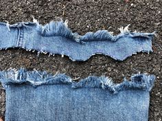 a pair of jeans that have been torn and are laying on the ground next to each other