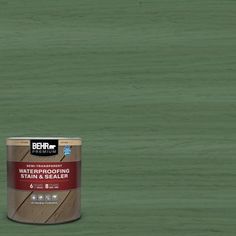 a can of behr waterproofing stain and sealer on a green background