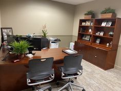 an office with two chairs and a desk