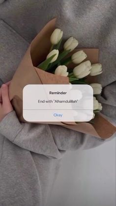 someone holding a bunch of flowers with the text reminder