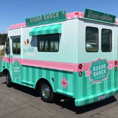 an ice cream truck parked in a parking lot next to another vehicle with the words sugar shack on it's side