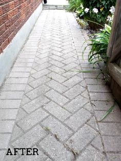 a brick sidewalk that has been cleaned and is in the process of being cleaned by someone